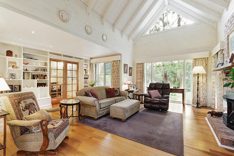 A Storybook cottage nestled among tall trees in Kallista, Victoria